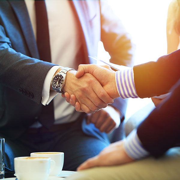 handshake across desk of lawyer