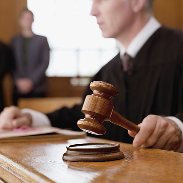 judge holding gavel in courtroom